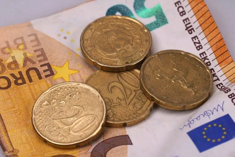closeup-on-euro-paper-note-with-four-20-cent-coins-2023-11-27-05-36-52-utc-768x512.jpg