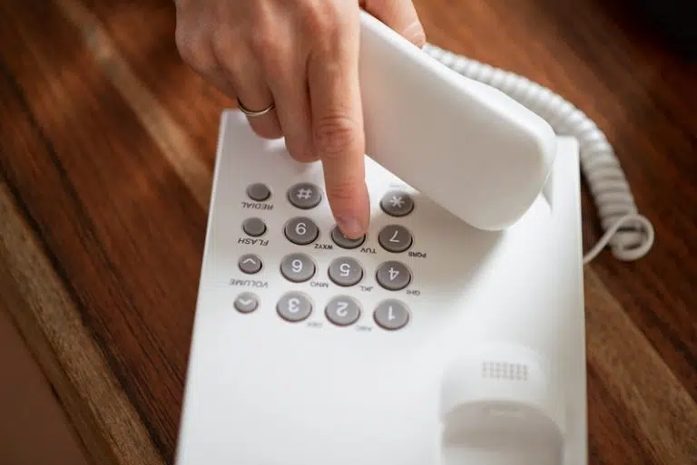 female-hand-holding-telephone-receiver-dialing-a-p-2023-11-27-05-22-10-utc-768x513.jpg