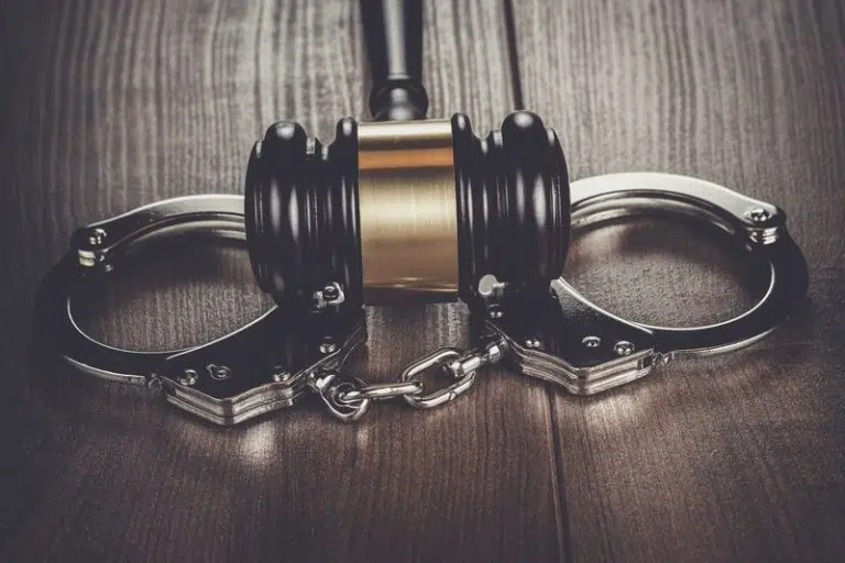 handcuffs-and-judge-gavel-on-brown-wooden-table-2023-11-27-05-24-07-utc-768x512.jpg