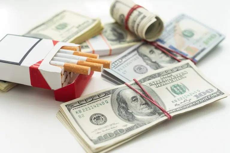 white-cigarettes-lying-on-the-dollar-bills-concep-2025-01-08-02-54-44-utc-768x512.jpg